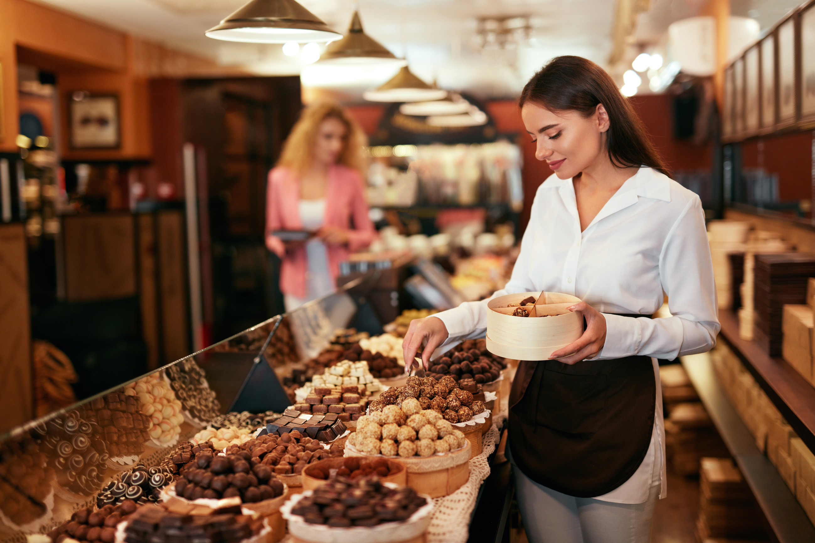 Chocolate Store. Woman Working In Chocolate Shop